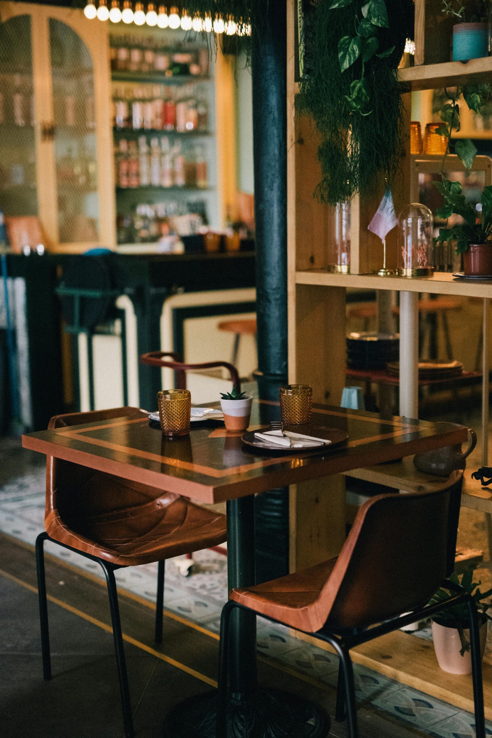 A stylish and modern bar with wooden seating, ready for guests. Perfect ambiance.